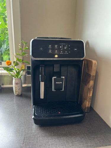 a black coffee maker is sitting on a counter at Hyggeligt hus i Haderslev med wellness og massage in Haderslev
