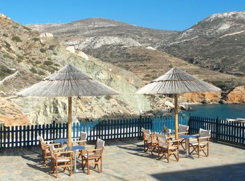 a group of tables and chairs with umbrellas at Pasithea Folegandros in Agali