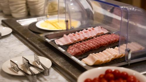 a bunch of different types of meats and cheese at Hotel Cruise in Lucino