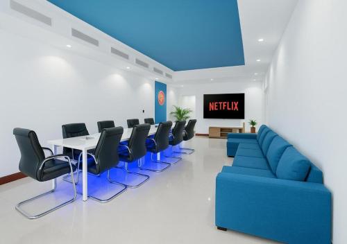 a waiting room with a blue couch and chairs at Teremok Holiday Homes in Dubai