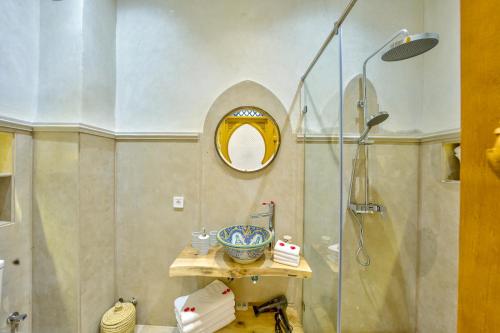 a bathroom with a shower with a glass door at Riad AL-Ghazlan Hamam & Spa in Marrakech