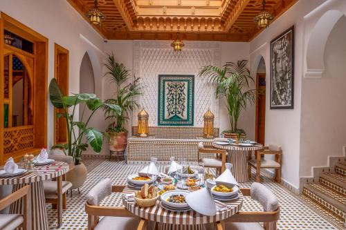 a restaurant with tables and chairs with food on them at Riad AL-Ghazlan Hamam & Spa in Marrakech