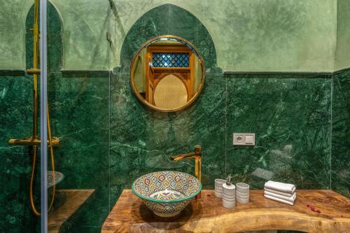 a bathroom with a sink and a mirror at Riad AL-Ghazlan Hamam & Spa in Marrakech