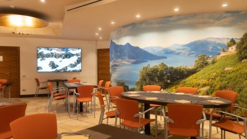 a conference room with a large painting on the wall at Hotel Cruise in Lucino