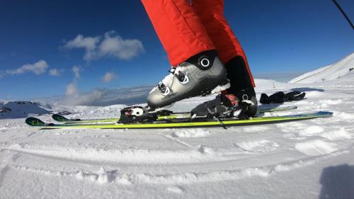 a person is standing on skis in the snow at Drau Lodge in Wernberg