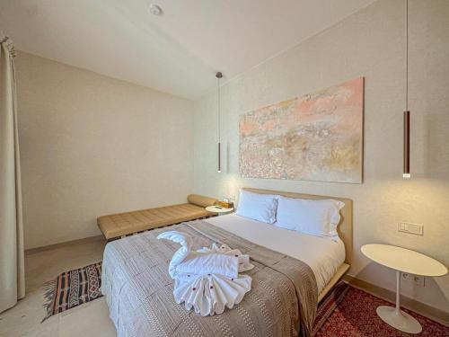 a bedroom with a bed with a swan on it at Riad Timija in Marrakech