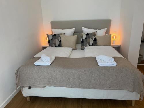 a bedroom with a large bed with two towels on it at Boutique Hotel am Schillerplatz in Dresden