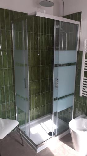 a glass shower in a bathroom with a sink at Villa Demetrio Ars Hotel in Piacenza
