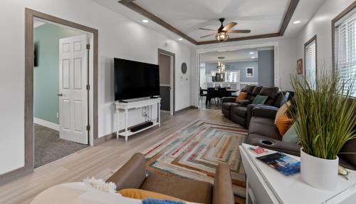 a living room with a couch and a tv at Downtown Fun Meets Ultimate Game Night in Muskegon