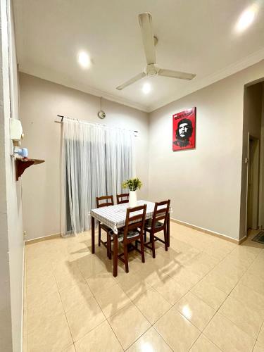 a dining room with a table and chairs at Homestay Kemaman - Berado D Kemuning in Cukai