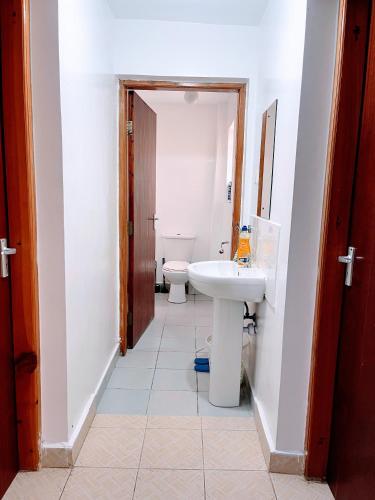 a bathroom with a sink and a toilet at Elegant One Bedroom Apartment - Athi River - Kesit Anga in Athi River