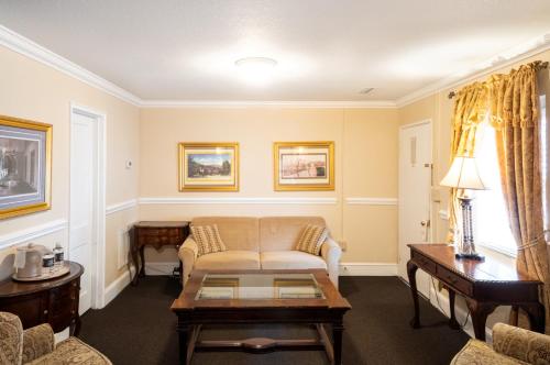 a living room with a couch and a table at Lake Lure Inn and Spa in Lake Lure