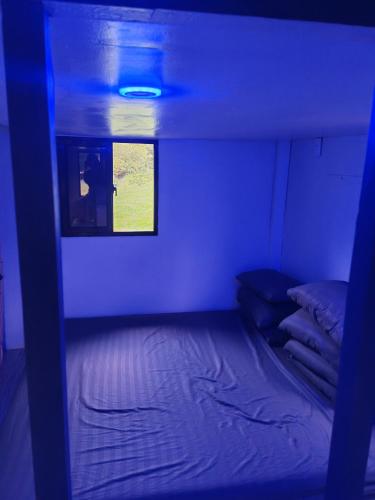 a small room with a bed and a window at Loong transient house in San Antonio