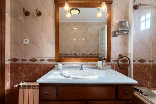 a bathroom with a sink and a mirror at La Ballena Beach by Next Stop Bilbao in Castro-Urdiales