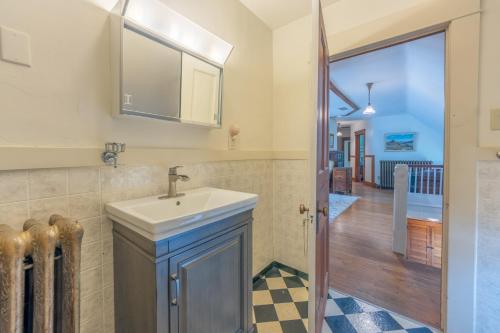 a bathroom with a sink and a hallway at Elsie in Benton Harbor