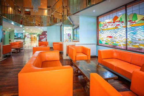 an orange restaurant with orange chairs and a table at Hotel Servigroup La Zenia 4 Sup in Playas de Orihuela