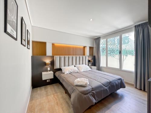 a bedroom with a large bed and a large window at Ayres Suites Cochabamba in Buenos Aires