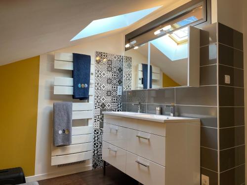 a bathroom with a sink and a mirror at Typical Toulouse house completely renovated in Launaguet