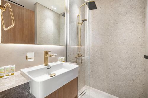 a bathroom with a sink and a shower at Private Pool! Exceptional 2 Bedroom! Brand New Building with Pool and Gym! in Dubai
