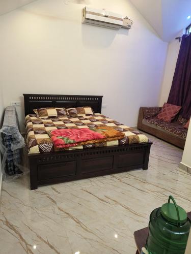 a bedroom with a bed and a couch at Twilight Home stay in Yelagiri