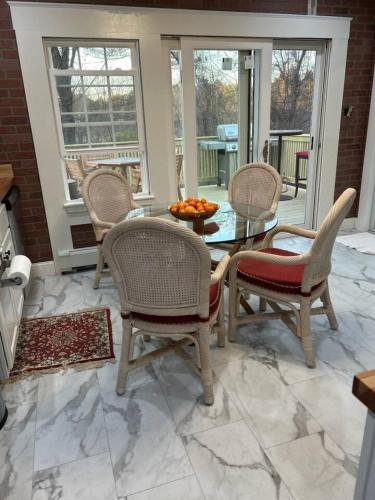 a dining room with a glass table and chairs at The Cozy Creamery in Plainville