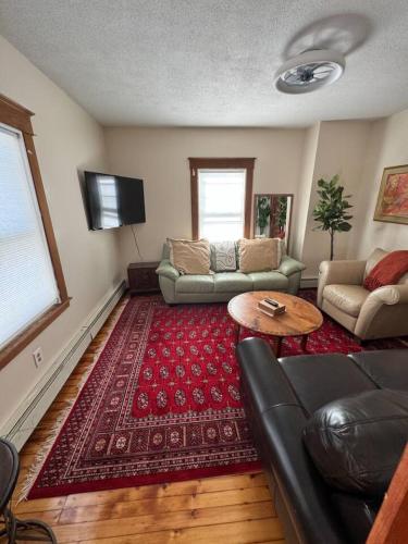 a living room with a couch and a table at The Cozy Creamery in Plainville