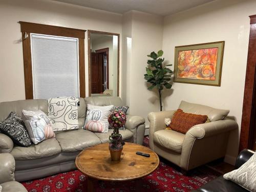 a living room with a couch and a table at The Cozy Creamery in Plainville