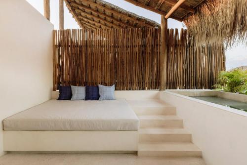 a bed on the side of a house at Itzel Samsara Dream Penthouse in Tulum