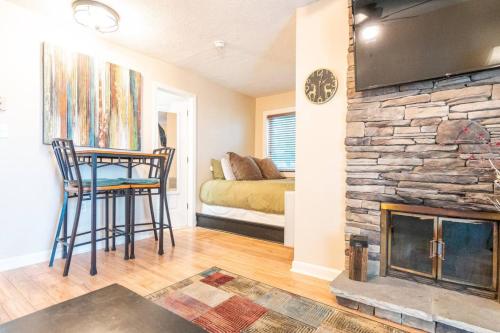 a living room with a stone fireplace and a bedroom at First floor, Studio, Resort Access, Portable AC in Beech Mountain