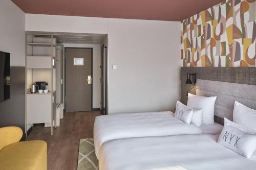 a hotel room with two beds and a kitchen at NYX Hotel Berlin Köpenick by Leonardo Hotels in Berlin