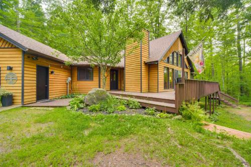 a wooden house with a porch and a deck at Cozy Wisconsin Cabin with Deck, Kayaks and Lake Views! in Hayward