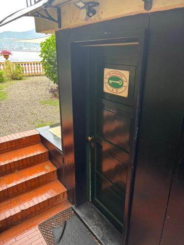 a door with a sign on it next to some stairs at B&B Ladidi in Rapallo