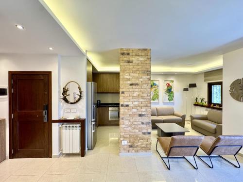 a living room with a couch and a table at Sapa - 2-BR w Terrace in Faraya in Fārayyā