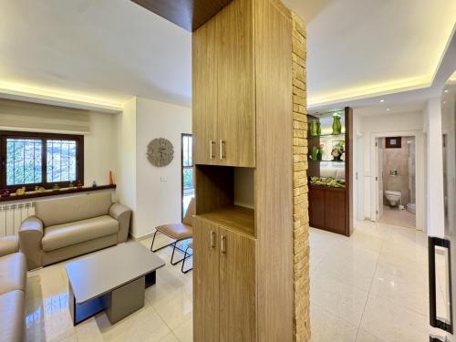 a living room with a couch and a table at Sapa - 2-BR w Terrace in Faraya in Fārayyā