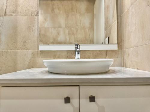 a bathroom with a white sink and a mirror at Sapa - 2-BR w Terrace in Faraya in Fārayyā
