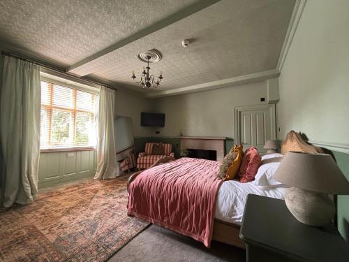 a bedroom with a large bed and a window at Halford House - Adults Only in Bourton on the Water