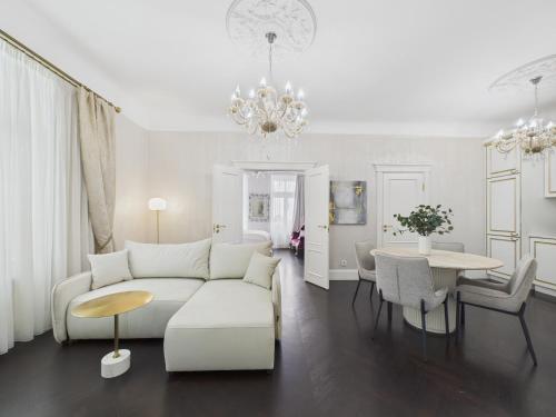 a living room with a white couch and a table at Vāgnera Rezidence in Rīga