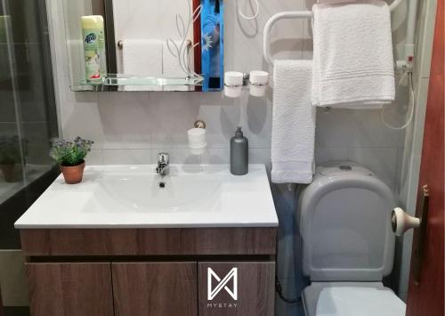 a bathroom with a sink and a toilet at MyStay - Casa Aguarela in São Romão