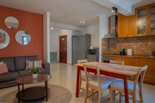 a kitchen and living room with a table and chairs at Old Town Church Bells in Kotor