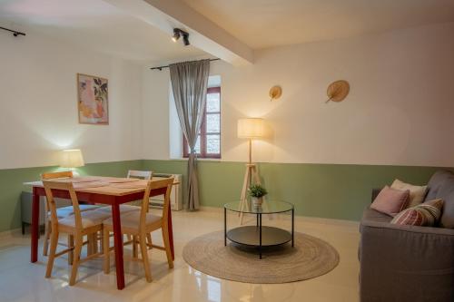 a living room with a table and a couch at Old Town Church Bells in Kotor