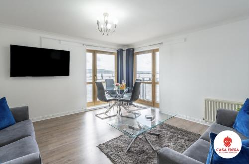 a living room with a couch and a table at Casa Fresa - City Quay Apartment in Dundee