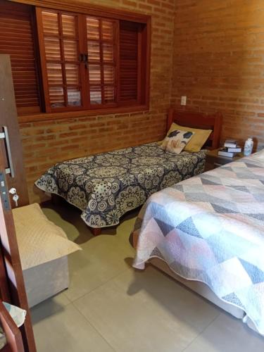 a bedroom with two beds in a room at Vinhedos da Serra com Ar quente e frio até 5 pessoas in Espirito Santo Do Pinhal