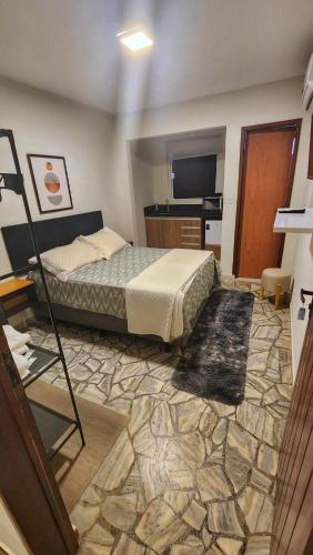 a bedroom with a bed and a television in it at Mirassol Flats in Natal