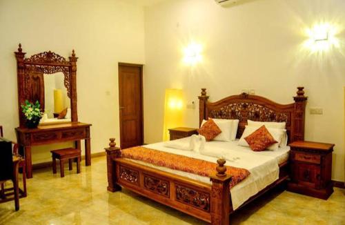 a bedroom with a large wooden bed and a mirror at The Elite Villa by Surf & Ride 