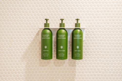 three green bottles of wine on a wall at RESET Hotel Joshua Tree in Twentynine Palms