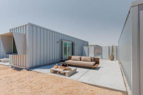 a living room with a couch and a table and a building at RESET Hotel Joshua Tree in Twentynine Palms