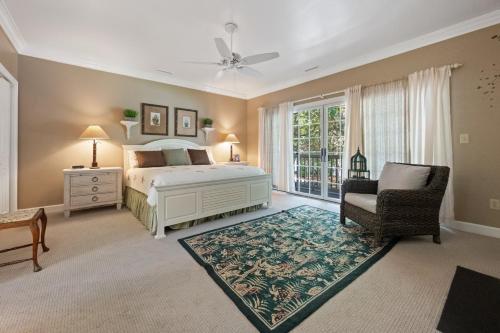 a bedroom with a bed and a chair and a window at Ruthie's Roost villa by Peace Vacations in Georgetown