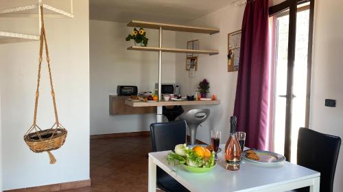a white table with a bowl of fruit on it at Celi Blu Apartments in Lizzanello