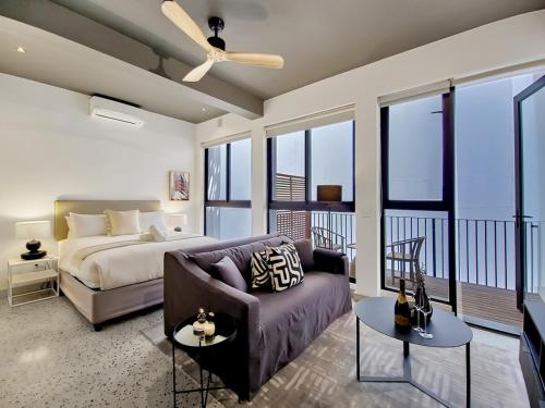 a living room with a bed and a couch at Brand new, luxury, wifi, pool with 24hr security in Cape Town