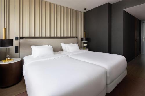 a large white bed in a hotel room at NH Collection Amsterdam Flower Market in Amsterdam